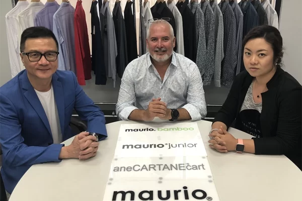 Highlife sourcing agency Finalising the purchase of the Maurio menswear labels - Maurio Menswear, Cartane, ATLAS and Perrone. Director Brad Tarr sits centre.