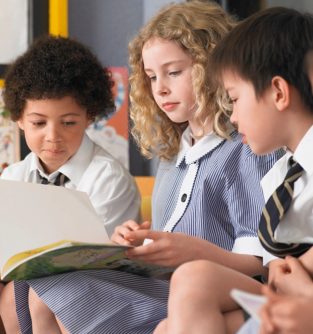 School kids in uniform reading